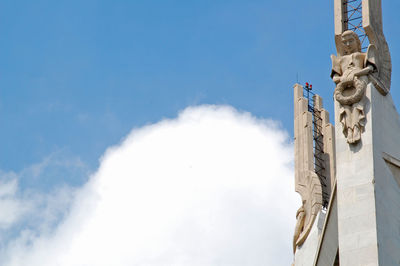 Low angle view of sculptures on building against sky