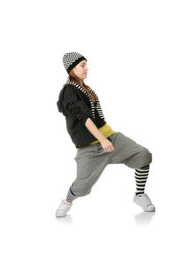 Full length of young woman standing against white background