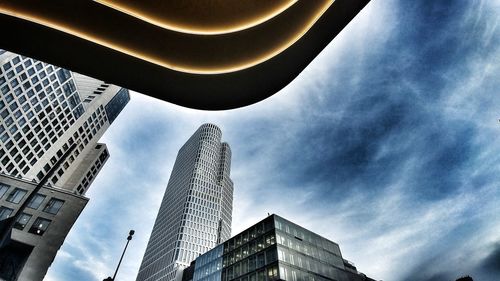 Low angle view of buildings against cloudy sky
