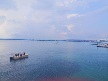 Boat sailing in sea against sky