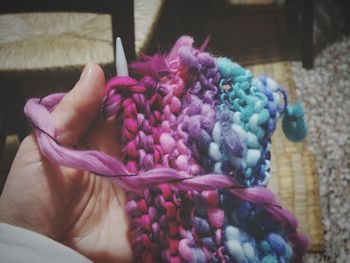 Close-up of hand holding pink flower