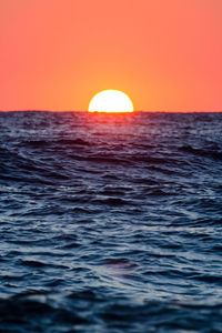 Scenic view of sea against orange sky