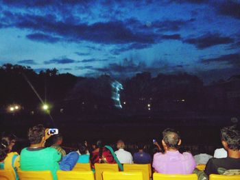 People in amusement park at night