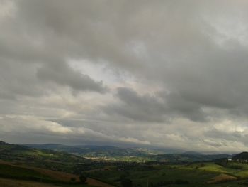 Scenic view of landscape against cloudy sky