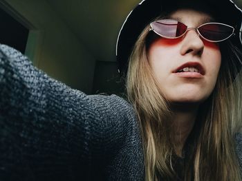 Close-up portrait of young woman at home