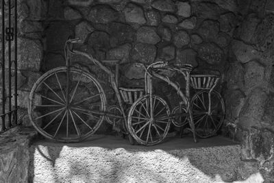 Bicycle parked by wall