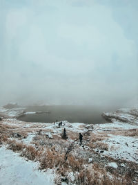 Snow covered land against sky