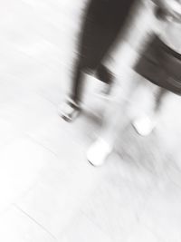 Blurred motion of people walking on road