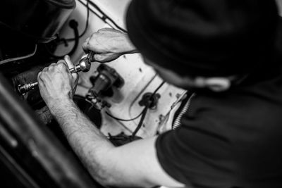 Close-up of mechanic repairing car