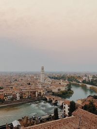 High angle view of townscape by sea against sky
