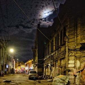 Cars on illuminated street in city at night