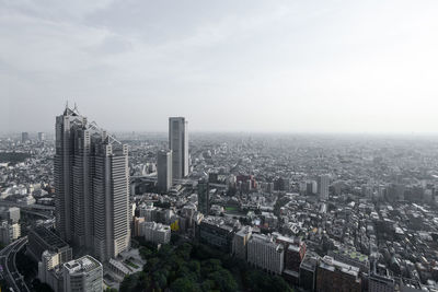 High angle view of modern buildings in city against sky