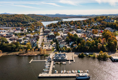 High angle view of townscape by sea against sky