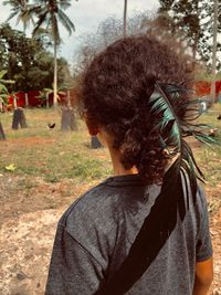 Rear view of man standing against trees