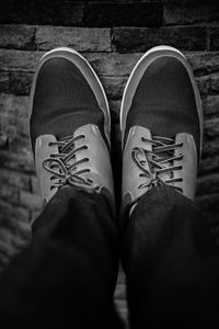 Low section of man standing on tiled floor