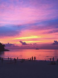 People on beach during sunset