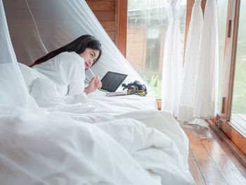 Young woman relaxing on bed at home