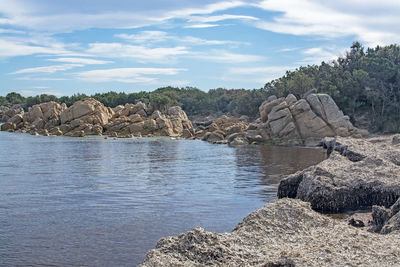 Rock formations by sea against sky