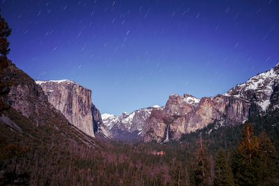 Scenic view of mountains against sky at night