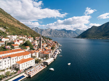 High angle view of townscape by sea against sky