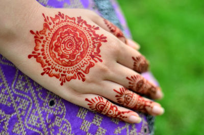 Close-up of woman with henna tattoo on hand