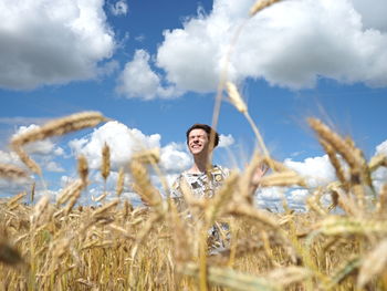  youngster arms raised standing on field against sky