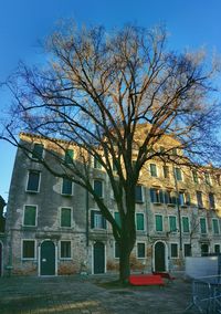 Low angle view of buildings against blue sky