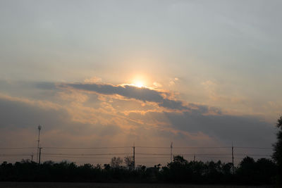 Silhouette trees against sky during sunset