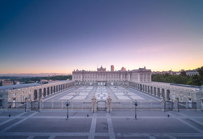 Magnificent scenery of royal palace of madrid and empty square in evening