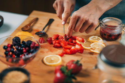 Midsection of man preparing food on table