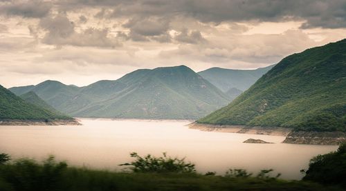 Scenic view of lake with mountains in background