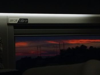 Low angle view of train against sky at sunset