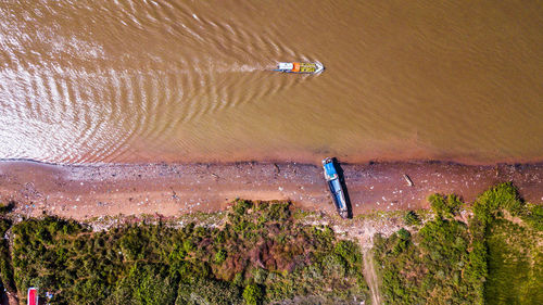 High angle view of man on shore against sky