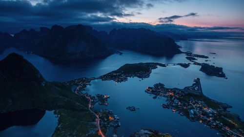 Scenic view of sea and mountains against sky