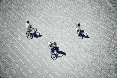 High angle view of people riding bicycle on street