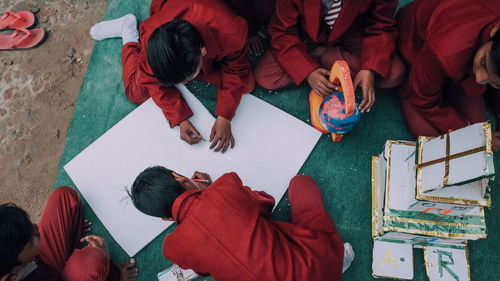 High angle view of people sitting on floor