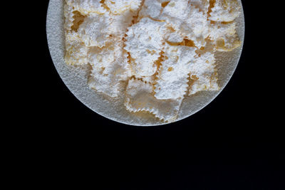 Close-up of ice cream over black background