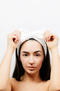 Portrait of a beautiful young woman over white background