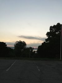 Empty road against sky during sunset