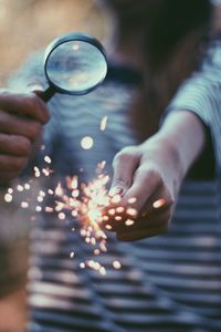 Close-up of hand holding sparkler