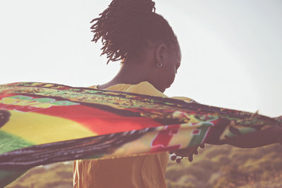 Low angle view of woman standing against sky
