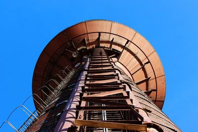 Low angle view of spiral staircase against blue sky