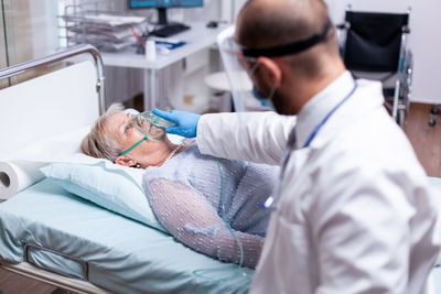 Midsection of doctor examining patient in clinic