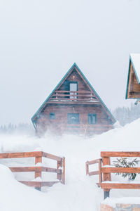 Built structure on snow covered landscape against clear sky