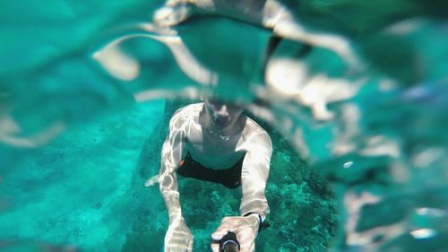 Man swimming in pool