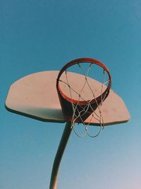 Low angle view of basketball hoop against blue sky