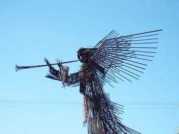 Low angle view of power lines against clear blue sky