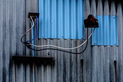 Metallic structure against blue wall
