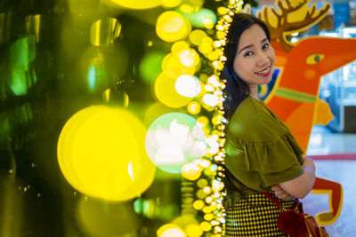 Portrait of a smiling young woman standing outdoors