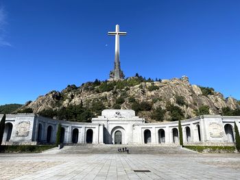 Low angle view of built structures against clear blue sky